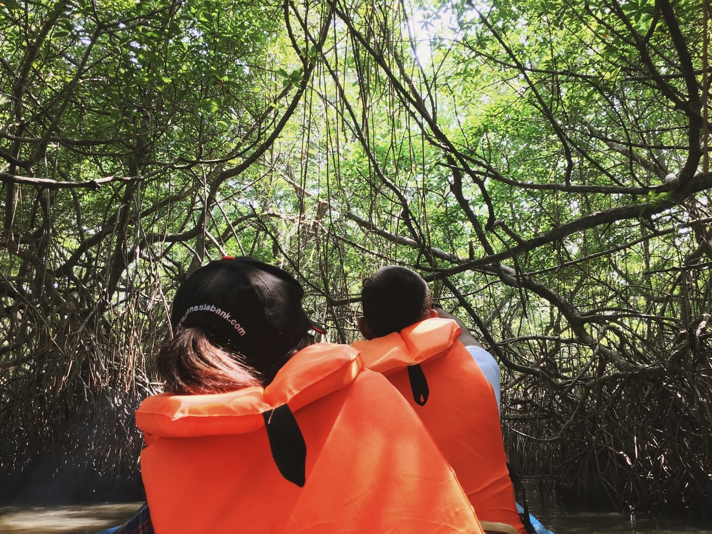 Visitors in life jackets exploring a Madu Ganga mangrove channel